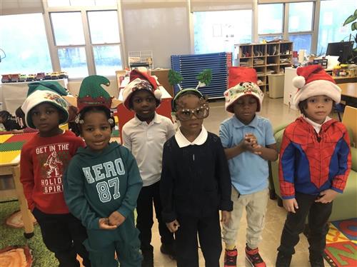 6 students wearing Santa hats